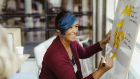 Woman writing on a white board
