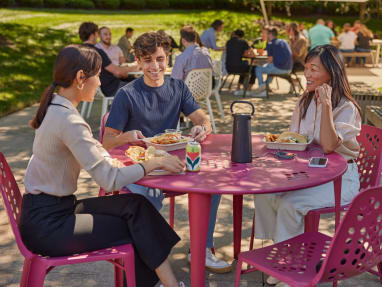 people in a social outdoor space eating
