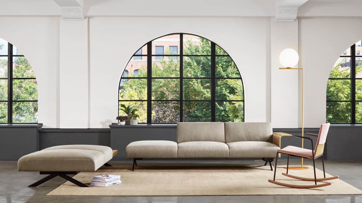 An office lounge area with windows features a Sistema lounge system and Montara650 rocker chair